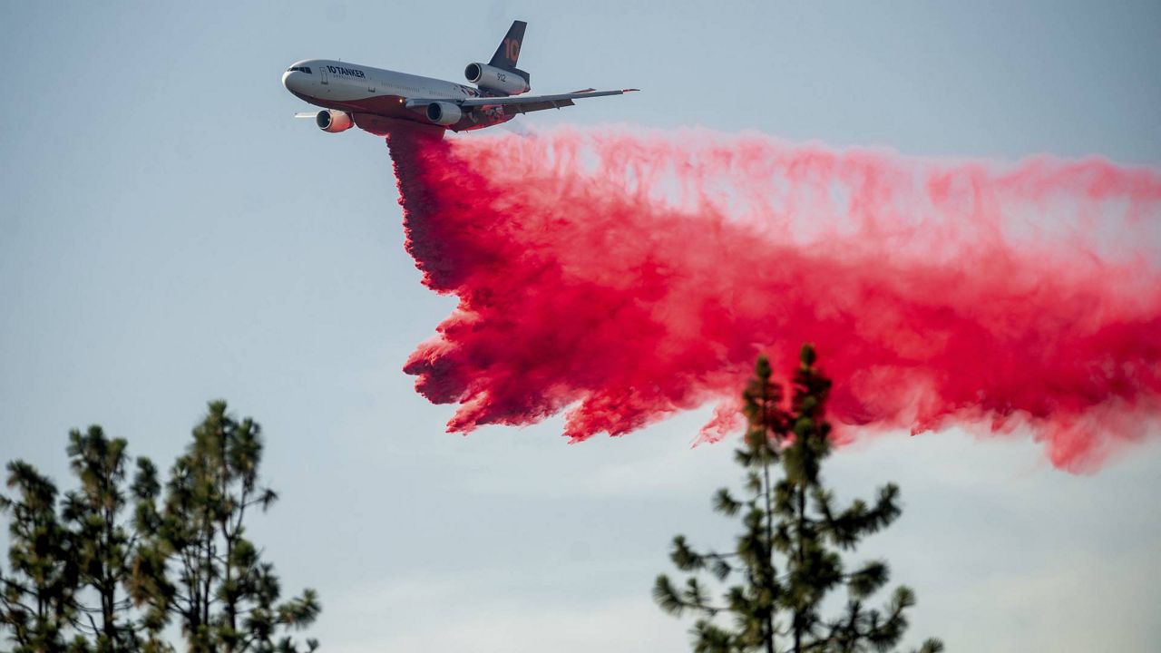 A DC-10 air tanker drops retardant while battling the Salt Fire near the Lakehead community of Unincorporated Shasta County, Calif., on Friday, July 2, 2021. (AP Photo/Noah Berger)