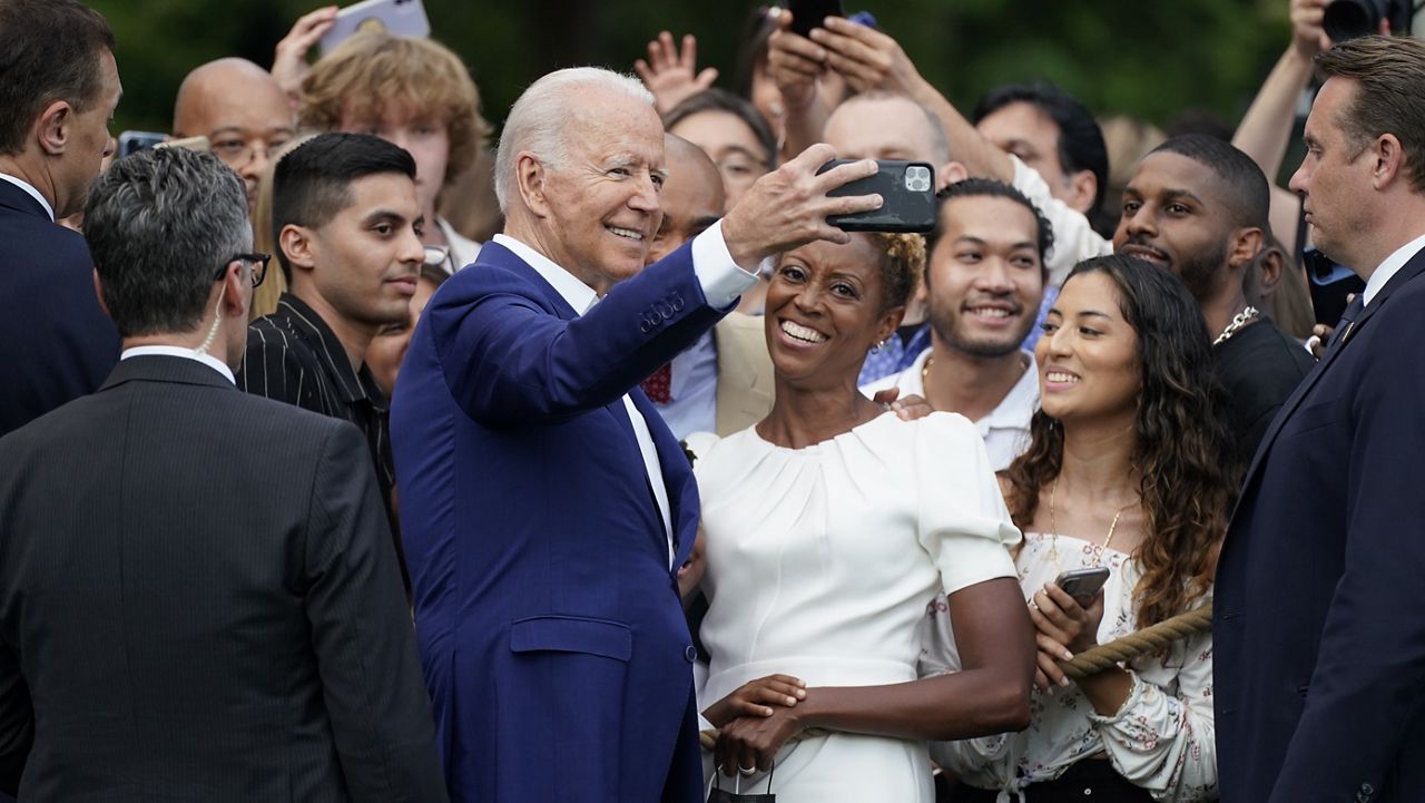 President Joe Biden poses for a photo with attendees during an Independence Day celebration on the South Lawn of the White House, Sunday, July 4, 2021, in Washington. (AP Photo/Patrick Semansky)