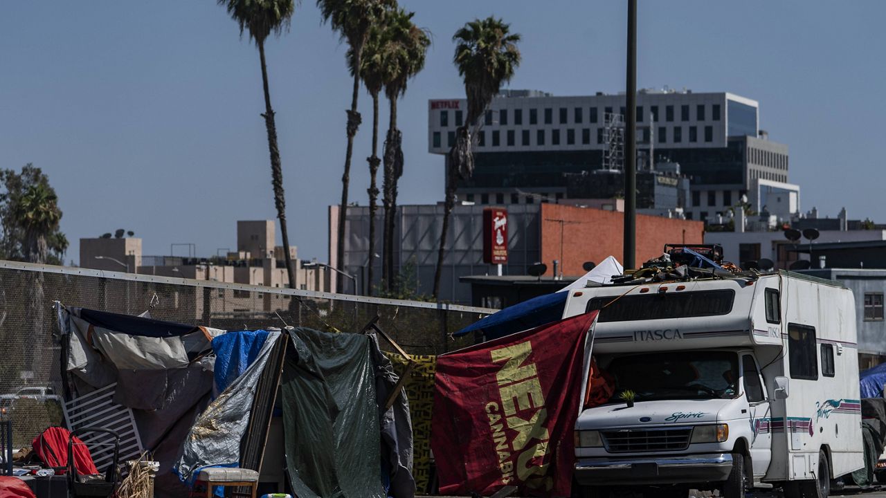 Homeless encampments are installed on an overpass of the CA-101 Hollywood freeway block the street sidewalks in Los Angeles Wednesday, July 7, 2021. (AP Photo/Damian Dovarganes)