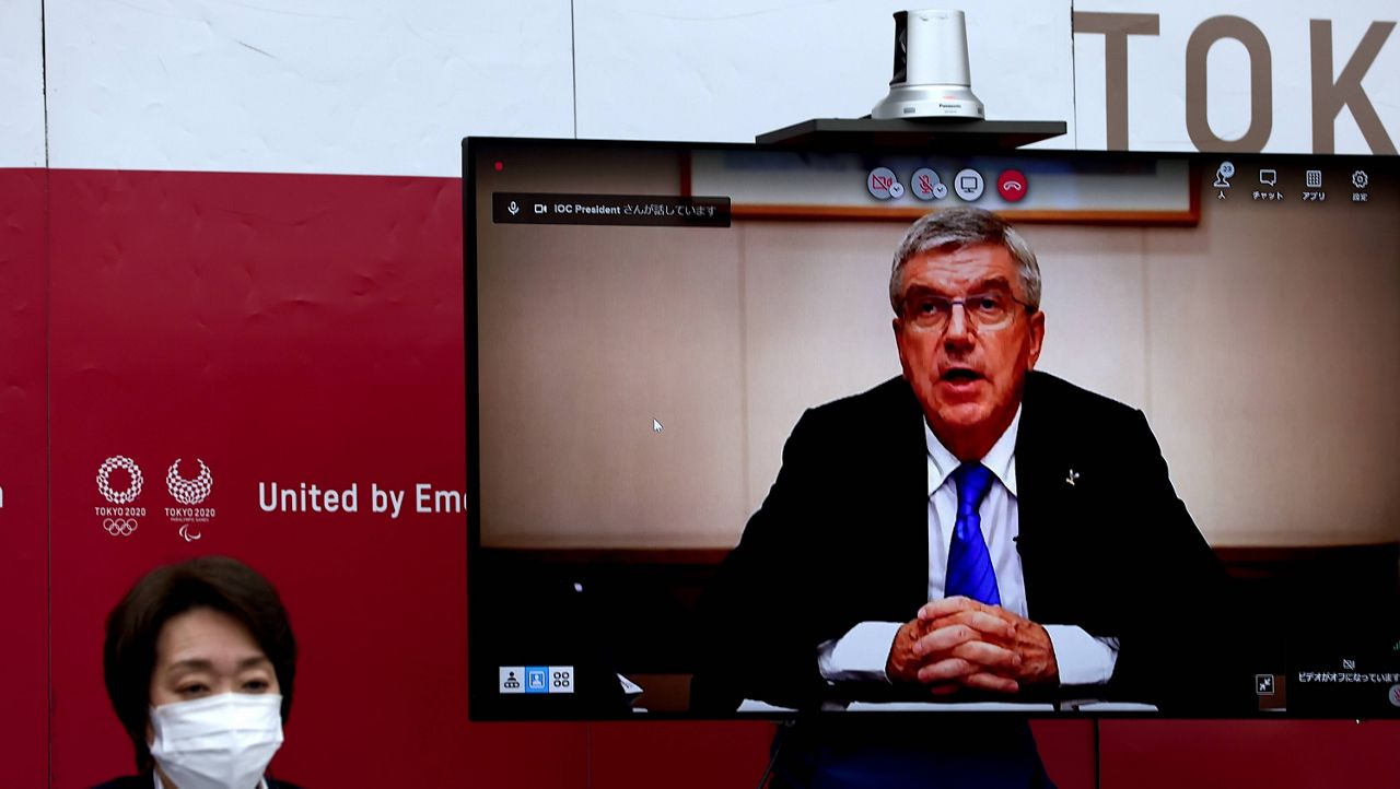 International Olympic Committee President Thomas Bach gestures on-screen with Tokyo 2020 president Seiko Hashimoto, left, at the beginning of the five-party meeting in Tokyo on Thursday. (Behrouz Mehri/Pool Photo via AP)