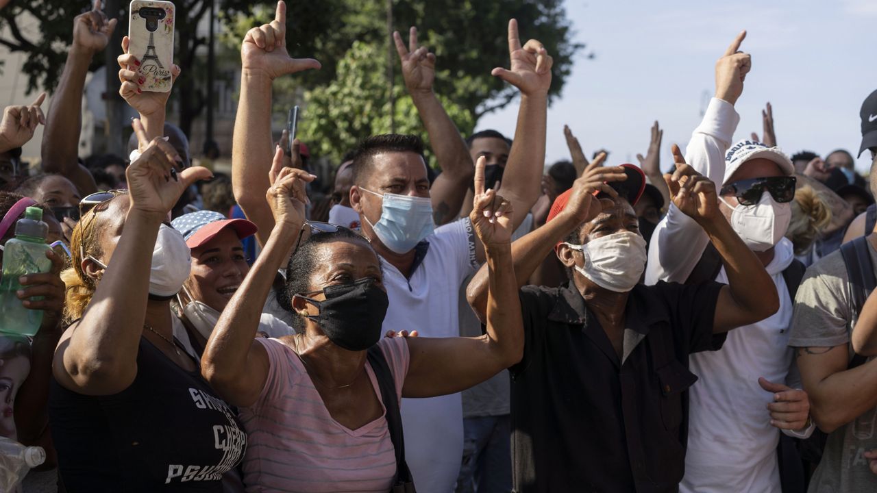 Anti-government protesters march in Havana, Cuba, Sunday, July 11, 2021. (AP Photo/Eliana Aponte)