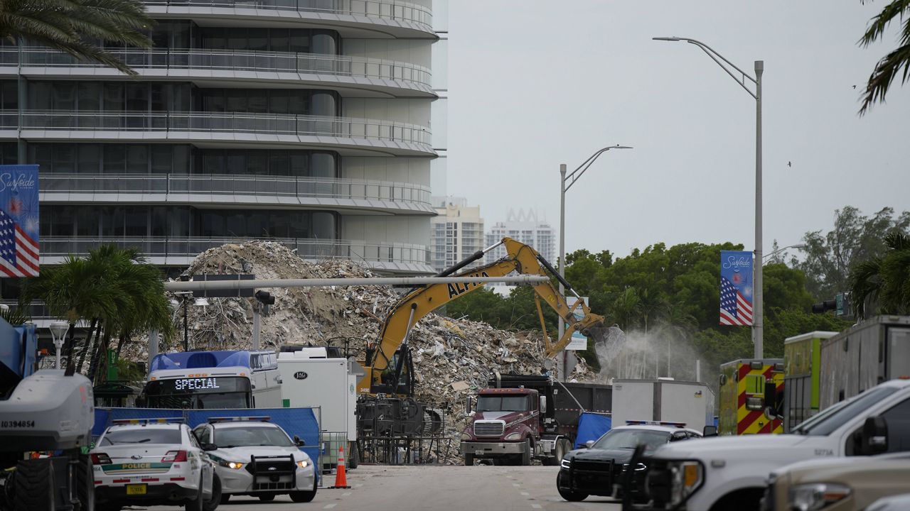 An excavator removes the rubble of the demolished section of the Champlain Towers South building on Monday in Surfside, Fla. (AP Photo/Rebecca Blackwell)