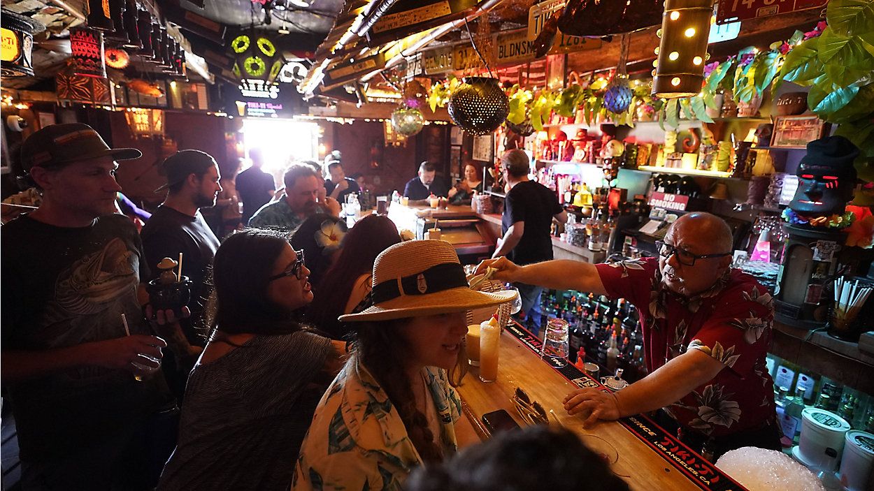 Patrons enjoy cold tropical cocktails at the Tiki-Ti bar on Sunset Boulevard in Los Angeles on July 7. (AP Photo/Damian Dovarganes, File)