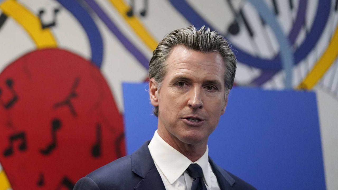 This July 13, 2021, file photo, California Gov. Gavin Newsom fields questions after a rally where he signed the California Comeback Plan relief bill in Los Angeles. (AP Photo/Marcio Jose Sanchez)