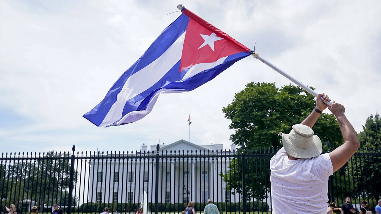 People participate in a rally outside the White House in Washington on Tuesday in support of the protesters in Cuba. 