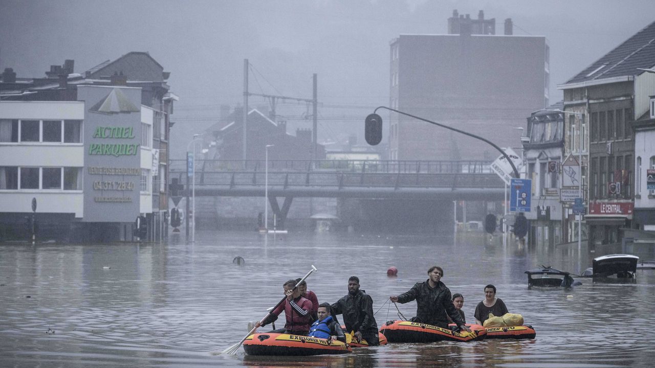 People use rubber rafts in floodwaters after the Meuse River broke its banks during heavy flooding in Liege, Belgium, on Thursday. (AP Photo/Valentin Bianchi)