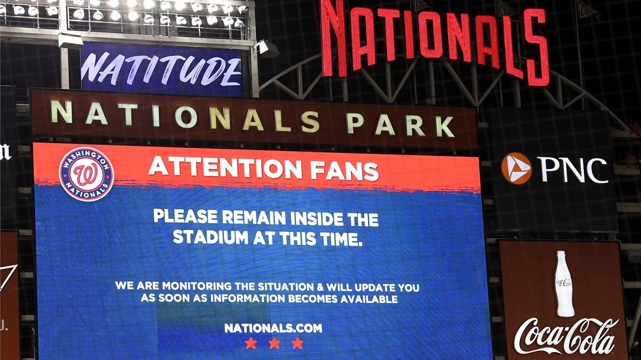 The scoreboard displays a message to fans during a stoppage in play due to an incident near the ballpark in the sixth inning of a baseball game between the Washington Nationals and the San Diego Padres, Saturday, July 17, 2021, in Washington. (AP Photo/Nick Wass)