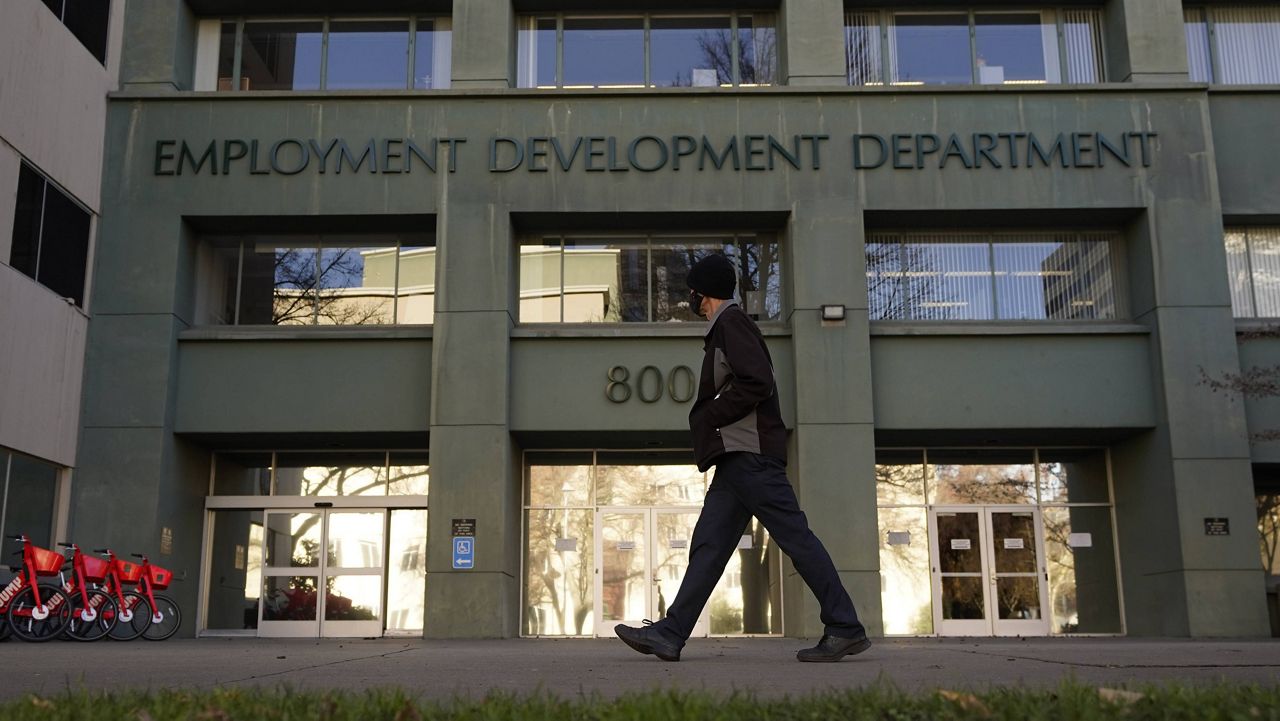 A person passes the office of the California Employment Development Department in Sacramento, Calif. (AP Photo/Rich Pedroncelli, File)