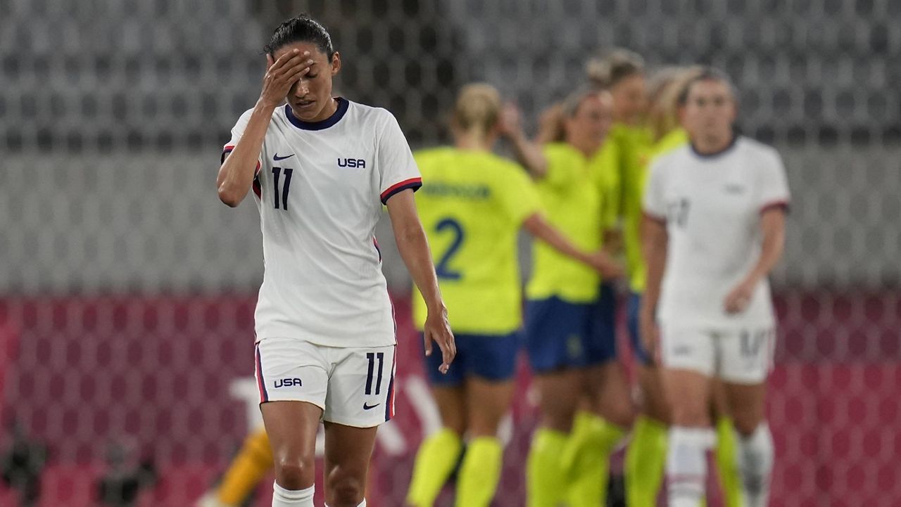 United States' Christen Press reacts as Sweden's players celebrate their third goal Wednesday at the Summer Olympics in Tokyo. (AP Photo/Ricardo Mazalan)