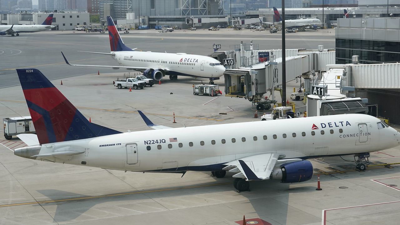 Delta Air Lines passenger jets rest on the tarmac, Wednesday, July 21, 2021, at Boston Logan International Airport, in Boston. (AP Photo/Steven Senne)