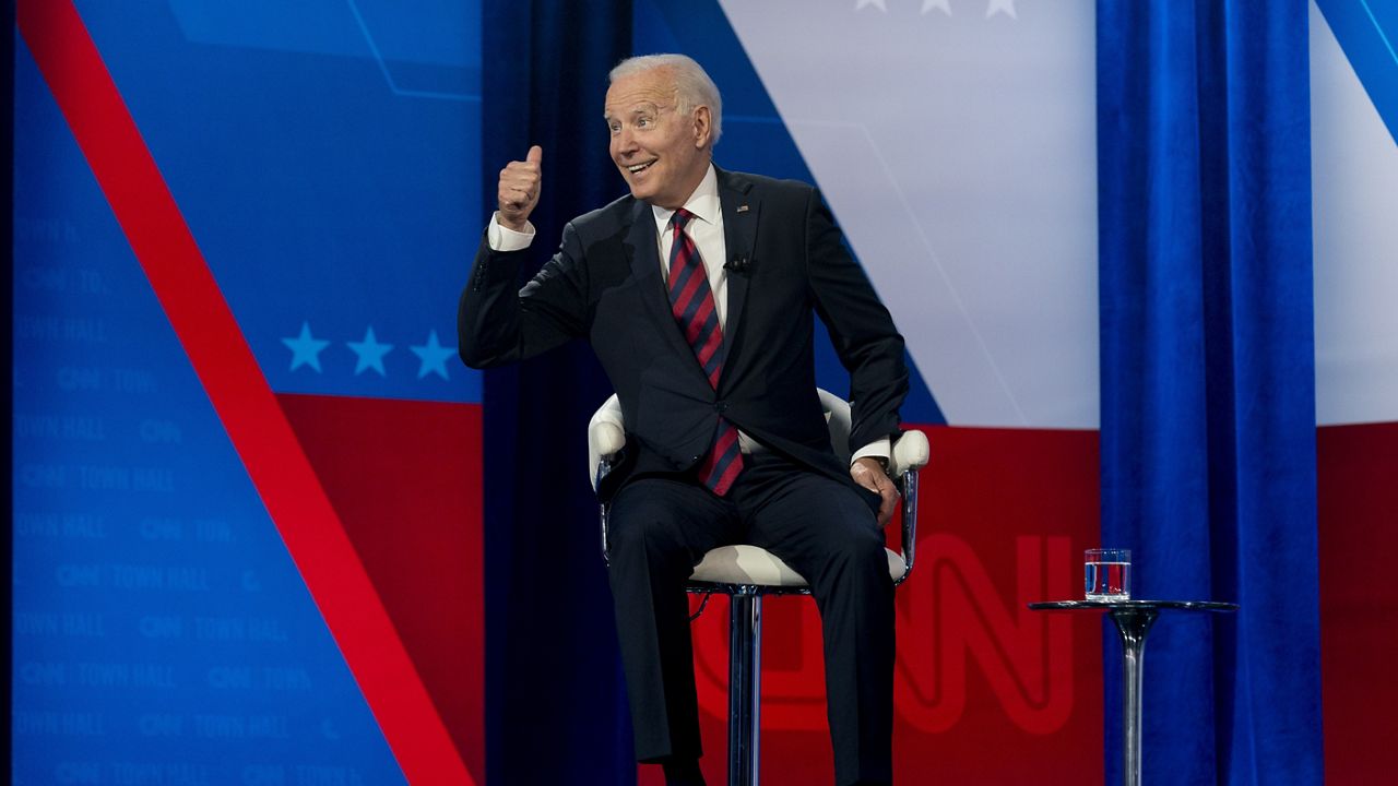 President Joe Biden interacts with members of the audience during a commercial break for a CNN town hall at Mount St. Joseph University in Cincinnati, Wednesday, July 21, 2021. (AP Photo/Andrew Harnik)