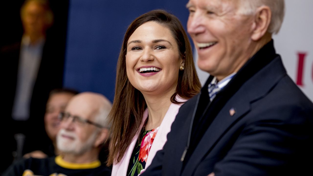 FILE - In this Friday, Jan. 3 2020 file photo, Democratic presidential candidate Joe Biden, right, and Rep. Abby Finkenauer, D-Iowa, center, smile during a campaign rally at the University of Dubuque, in Dubuque, Iowa. (AP Photo/Andrew Harnik)