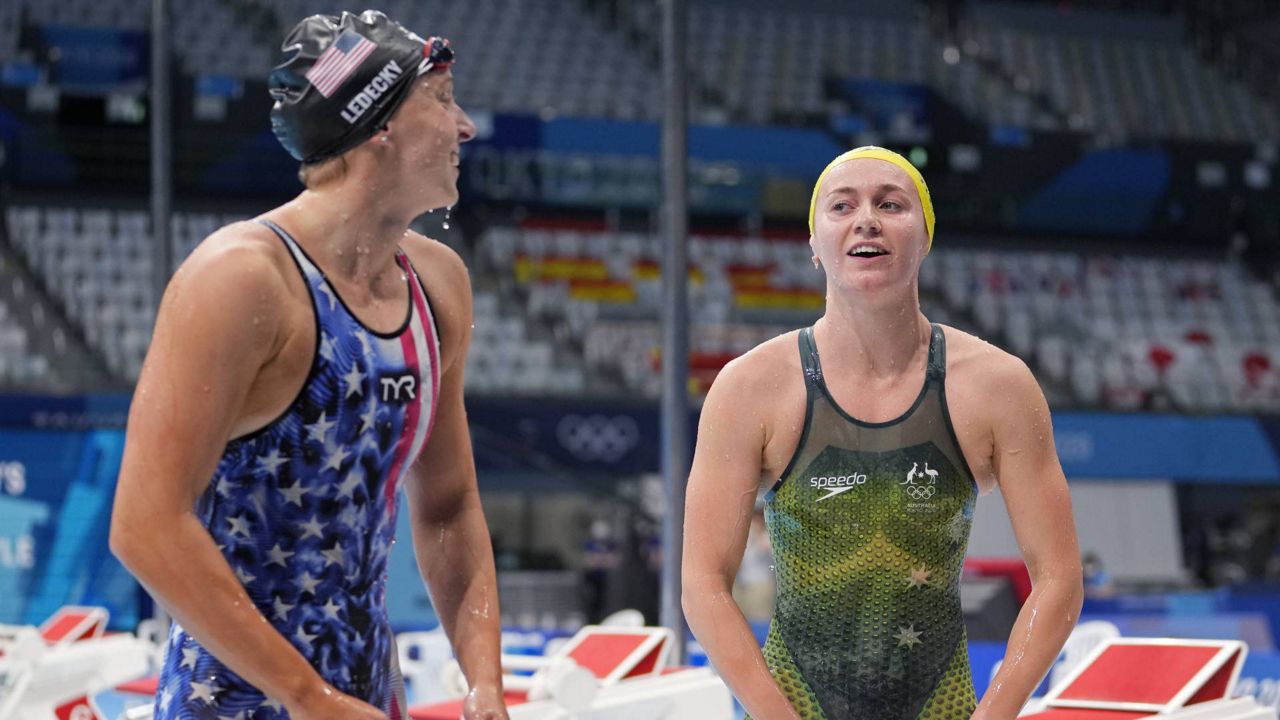 Ariarne Titmus of Australia, right, leaves the pool after winning the final of the women's 400-meters freestyle as Katie Ledecky of the U.S. watches at the Summer Olympics, Monday, July 26, 2021, in Tokyo, Japan. (AP Photo/Martin Meissner)