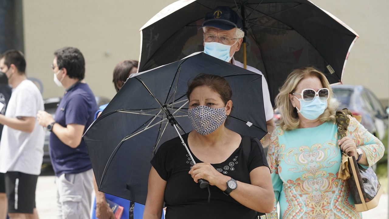 Angela Del Campo waits in line with others to get a COVID-19 rapid test Monday in Miami. (AP Photo/Marta Lavandier)