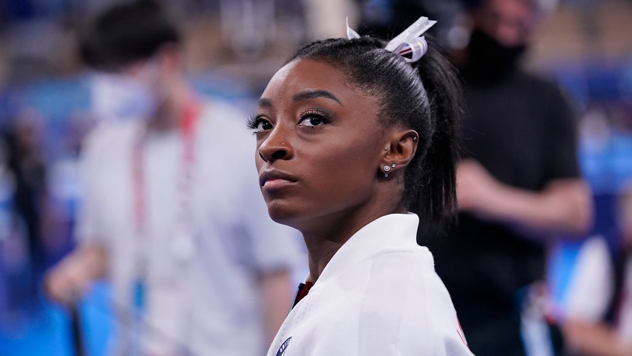 Simone Biles, of the United States, waits for her turn to perform during the artistic gymnastics women's final at the 2020 Summer Olympics, Tuesday, July 27, 2021, in Tokyo. (AP Photo/Gregory Bull)