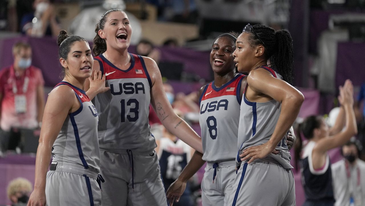 United States' Kelsey Plum, left, Stefanie Dolson (13), Jacquelyn Young (8) and Allisha Gray celebrate after defeating Russian Olympic Committee in a women's 3-on-3 gold medal basketball game at the 2020 Summer Olympics, Wednesday, July 28, 2021, in Tokyo, Japan. (AP Photo/Jeff Roberson)