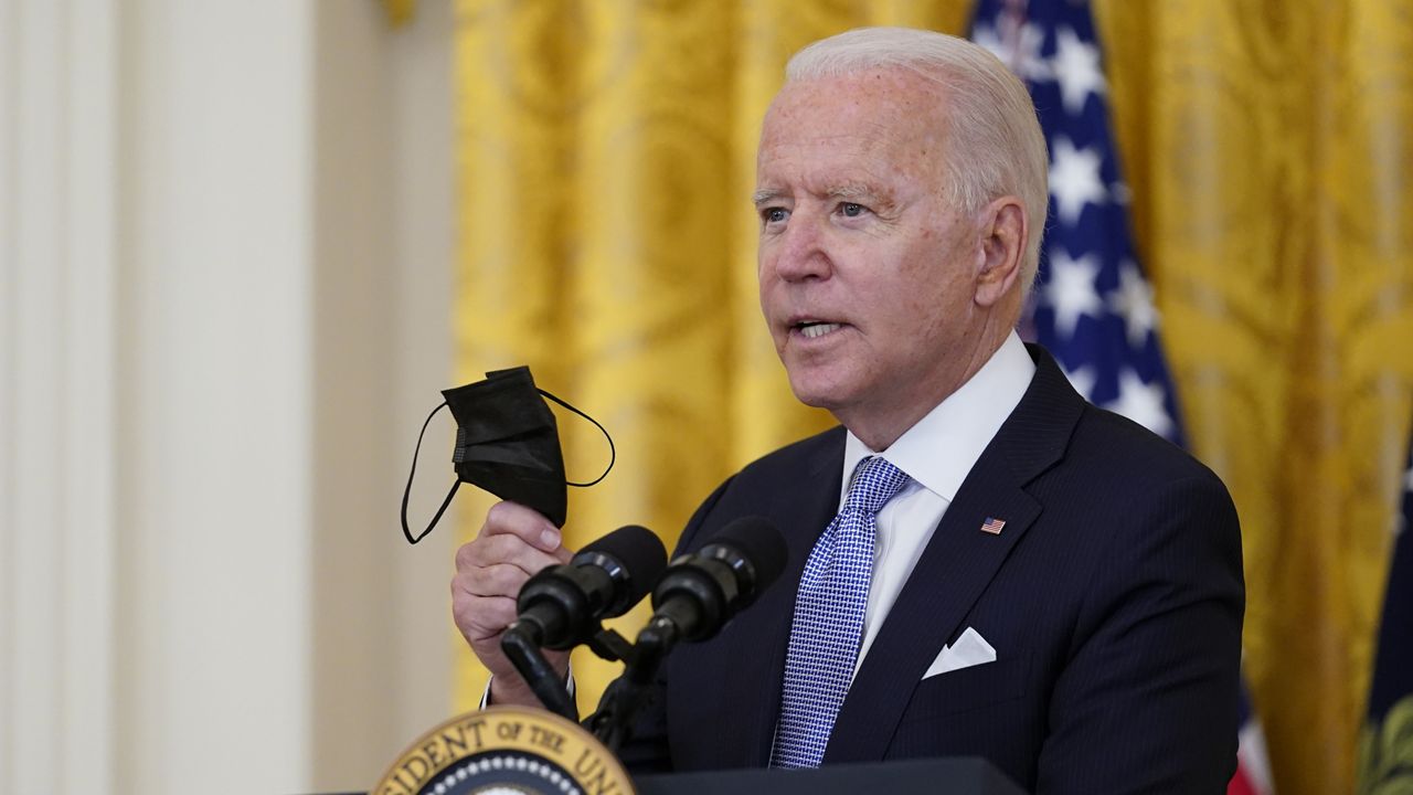 President Joe Biden holds a face mask as he announces from the East Room of the White House in Washington, Thursday, July 29, 2021, that millions of federal workers must show proof they've received a coronavirus vaccine or submit to regular testing and stringent social distancing, masking and travel restrictions in an order to combat the spread of the coronavirus. (AP Photo/Susan Walsh)