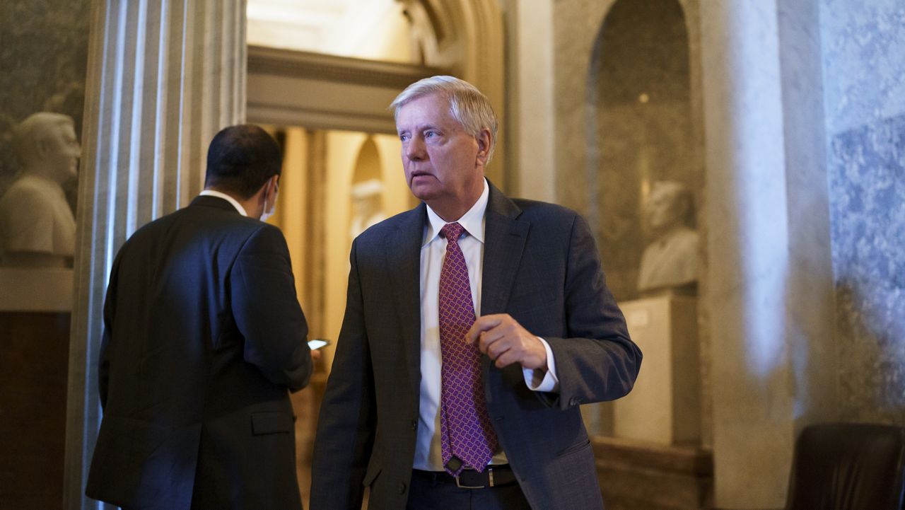 Sen. Lindsey Graham, R-S.C., leaves the chamber as the Senate advances to formally begin debate on a roughly $1 trillion infrastructure plan, a process that could take several days, at the Capitol in Washington, Friday, July 30, 2021. (AP Photo/J. Scott Applewhite)