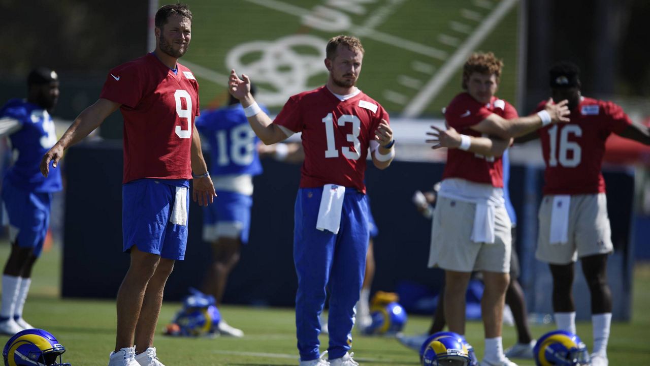 LA Rams quarterbacks Matthew Stafford, left to right, stretches with John Wolford, Devlin Hodges and Bryce Perkins during an NFL training camp practice in Irvine, Calif., July 31, 2021. (AP Photo/Kelvin Kuo)