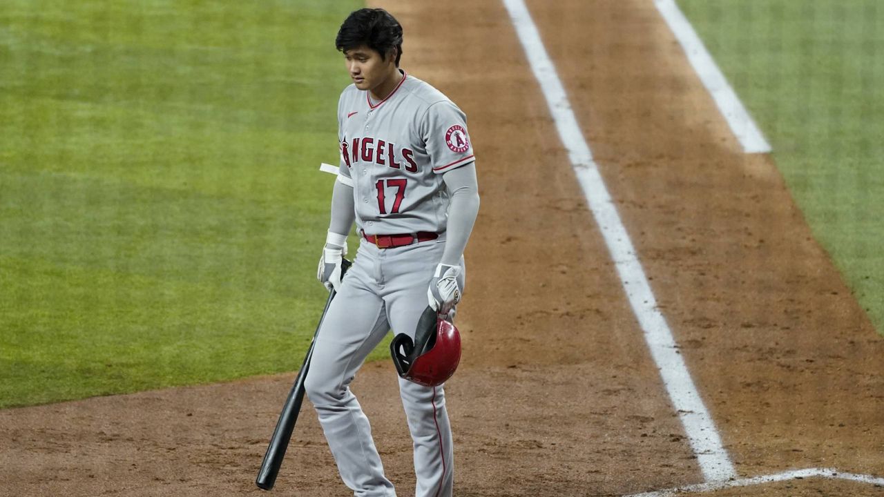 Los Angeles Angels' Shohei Ohtani walks to the dugout after striking out in the third inning of a baseball game against the Texas Rangers in Arlington, Texas, Monday, Aug. 2, 2021. (AP Photo/Tony Gutierrez)