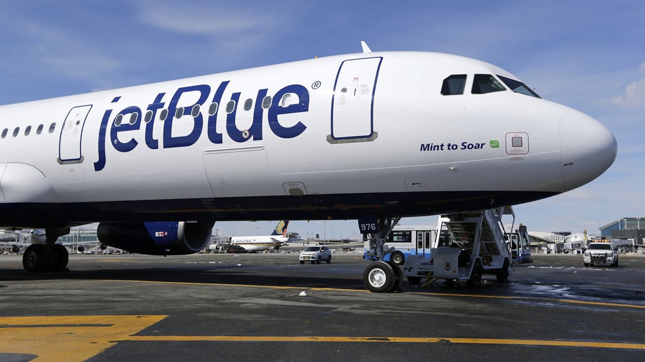 FILE- In this March 16, 2017, file photo, a Jet Blue airplane at John F. Kennedy International Airport in New York. (AP Photo/Seth Wenig, File)