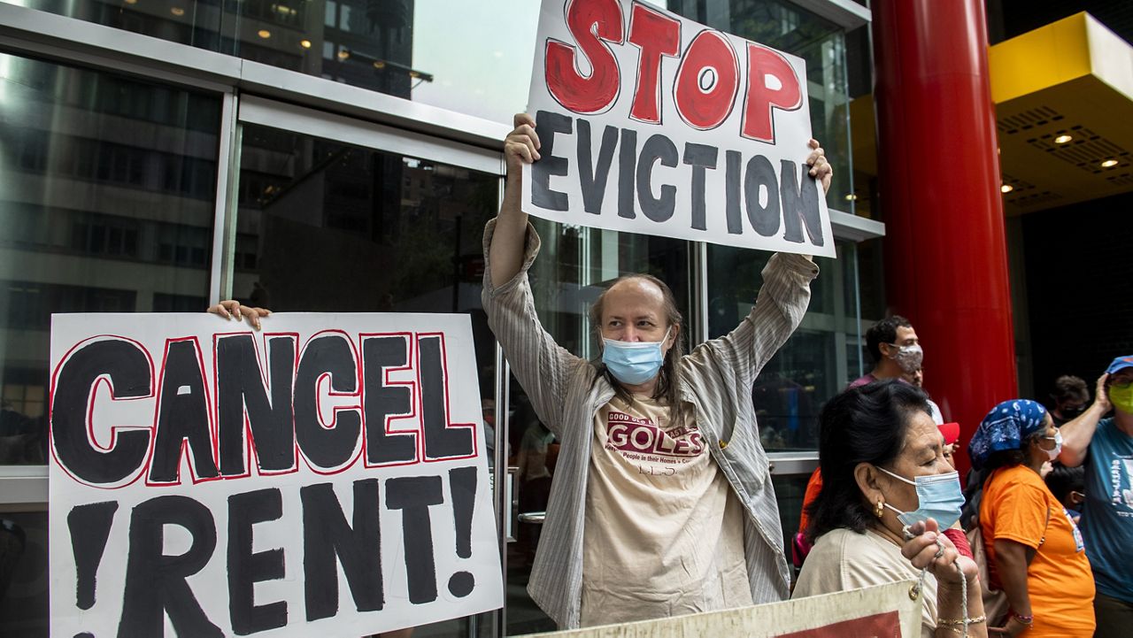 Housing advocates protest outside Governor Andrew Cuomo's office on the eviction moratorium on Wednesday, Aug. 4, 2021, in New York. (AP Photo/Brittainy Newman)