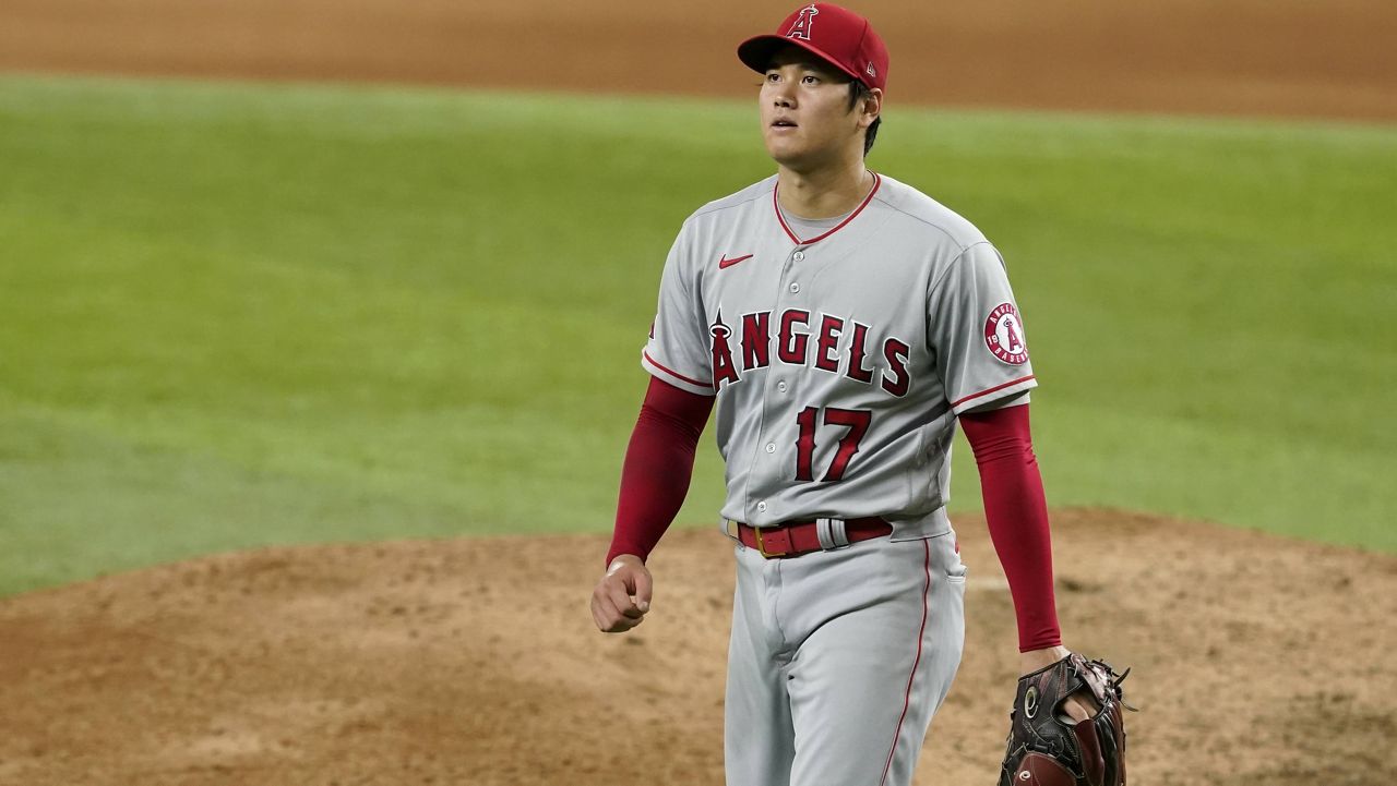 Los Angeles Angels starting pitcher Shohei Ohtani walks to the dugout after working in the sixth inning of the team's baseball game against the Texas Rangers in Arlington, Texas, Wednesday, Aug. 4, 2021. (AP Photo/Tony Gutierrez)