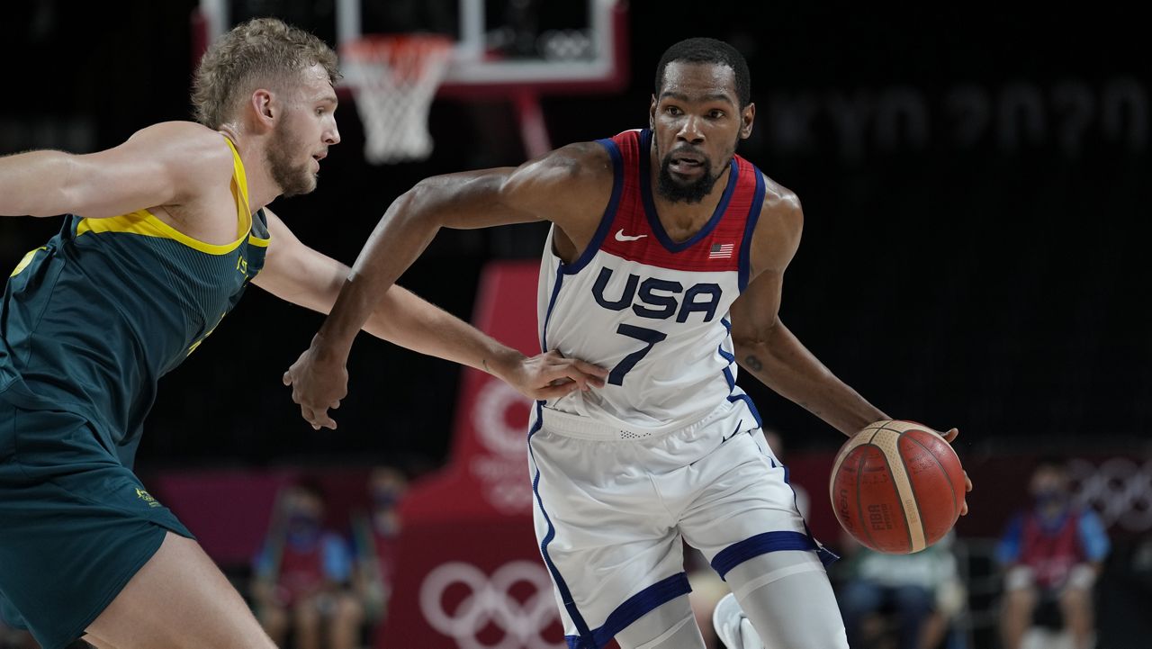 United States's Kevin Durant (7) drives against Australia's Jock Landale (13) during men's basketball semifinal game at the 2020 Summer Olympics, Thursday, Aug. 5, 2021, in Saitama, Japan. (AP Photo/Eric Gay)