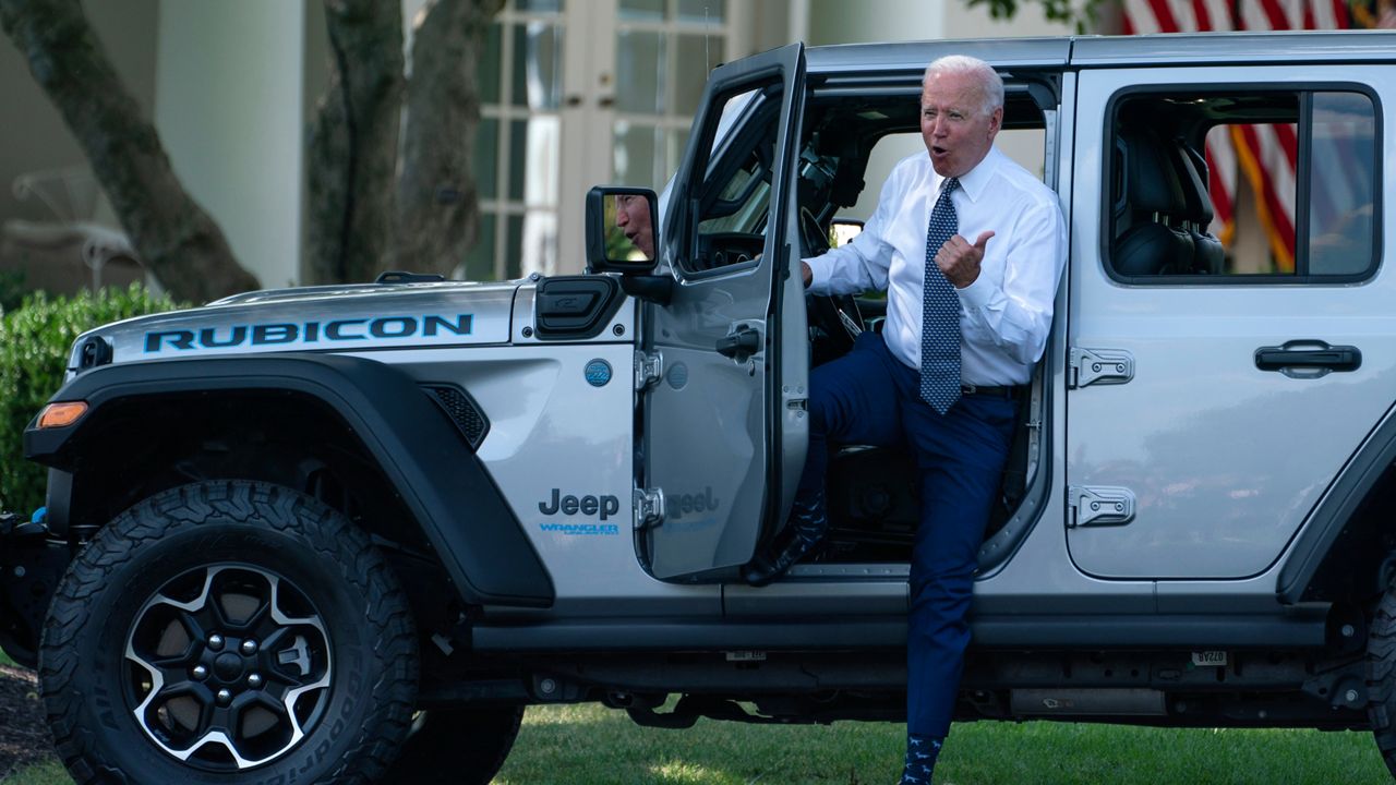 President Joe Biden gets out of a Jeep Wrangler Rubicon 4xE on the South Lawn of the White House in Washington, Thursday, Aug. 5, 2021, during an event on clean cars and trucks. (AP Photo/Evan Vucci)