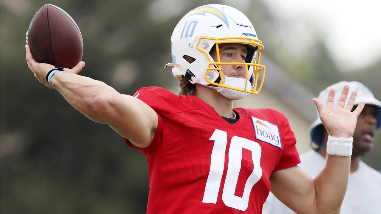 Los Angeles Chargers quarterback Justin Herbert throws a pass during NFL football practice in Costa Mesa, Calif., Friday, Aug. 6, 2021. (AP Photo/Alex Gallardo)