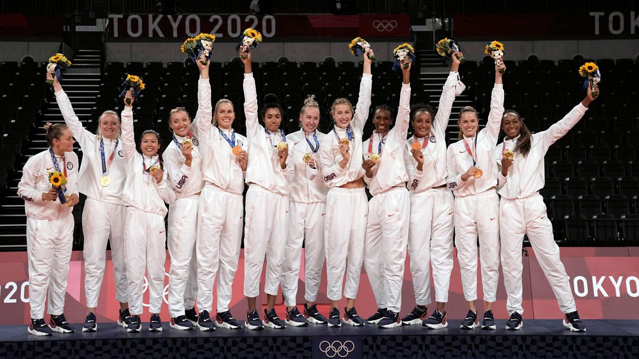 Players from the United States pose after winning the gold medal in women's volleyball at the 2020 Summer Olympics, Aug. 8, 2021, in Tokyo, Japan. (AP Photo/Manu Fernandez)