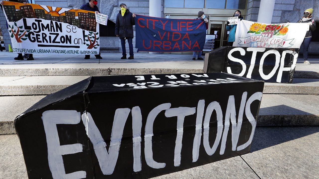In this Jan. 13, 2021, file photo, tenants' rights advocates demonstrate in front of the Edward W. Brooke Courthouse in Boston. (AP Photo/Michael Dwyer, File)