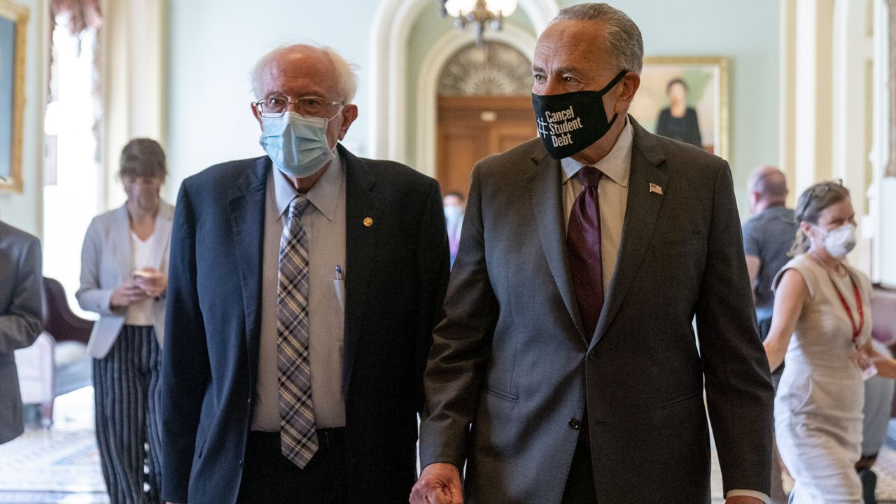 Sen. Bernie Sanders, I-Vt., left, and Senate Majority Leader Chuck Schumer of N.Y., right, walk out of a budget resolution meeting at the Capitol in Washington, Monday, Aug. 9, 2021. (AP Photo/Andrew Harnik)