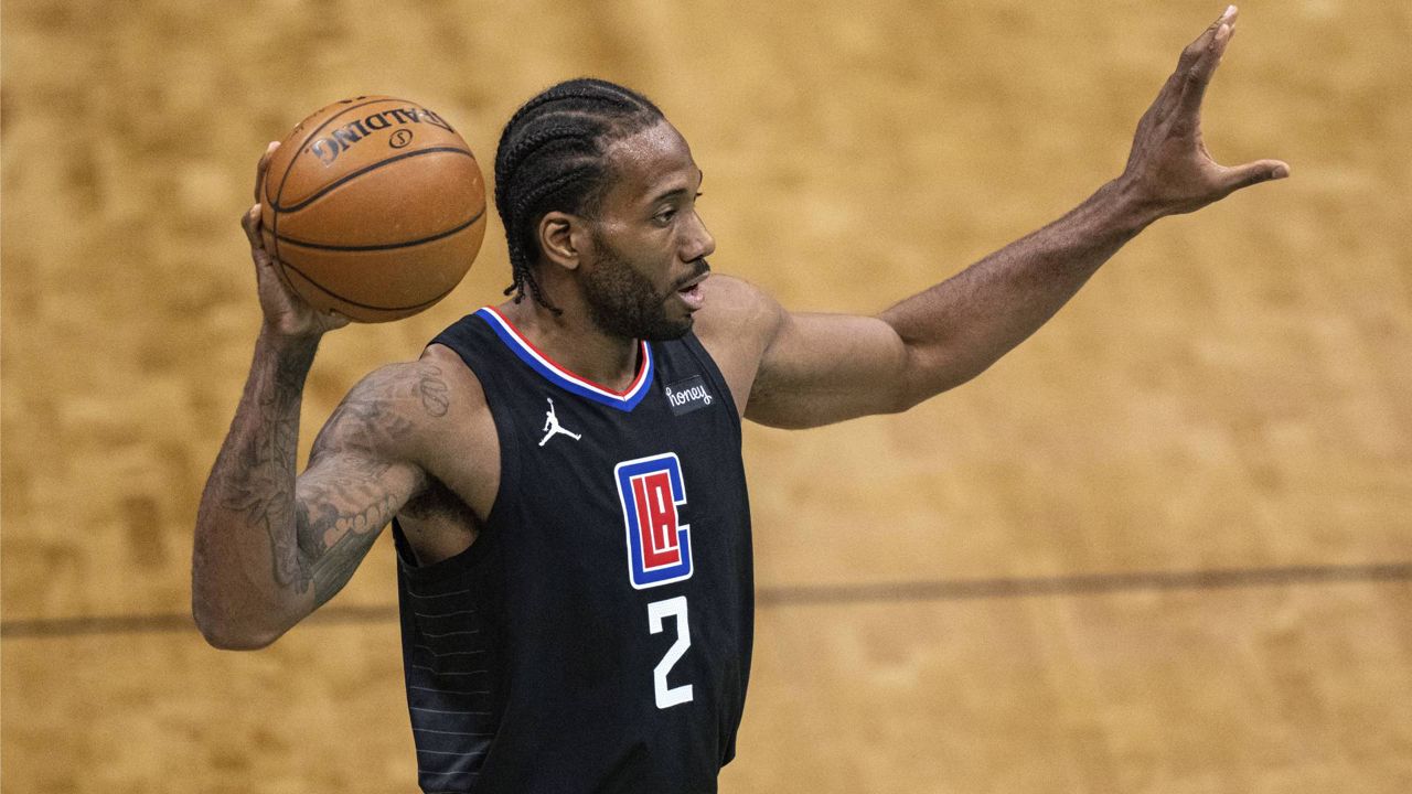 In this May 31, 2021, file photo, Los Angeles Clippers forward Kawhi Leonard looks to pass the ball during a game against the Charlotte Hornets in Charlotte, N.C. (AP Photo/Jacob Kupferman)