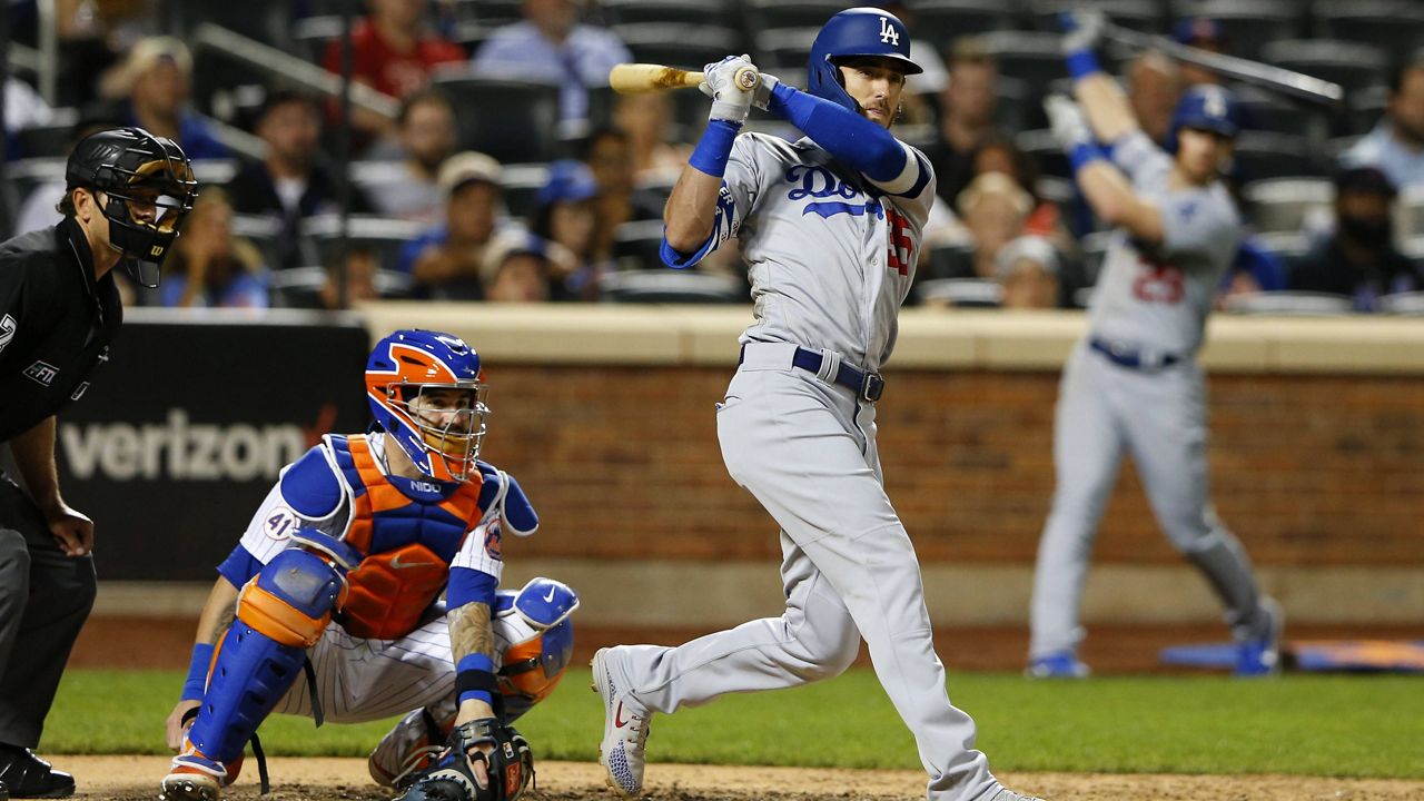 Los Angeles Dodgers' Cody Bellinger (35) follows through on a double against the New York Mets during the 10th inning of a baseball game Saturday, Aug. 14, 2021, in New York. (AP Photo/Noah K. Murray)