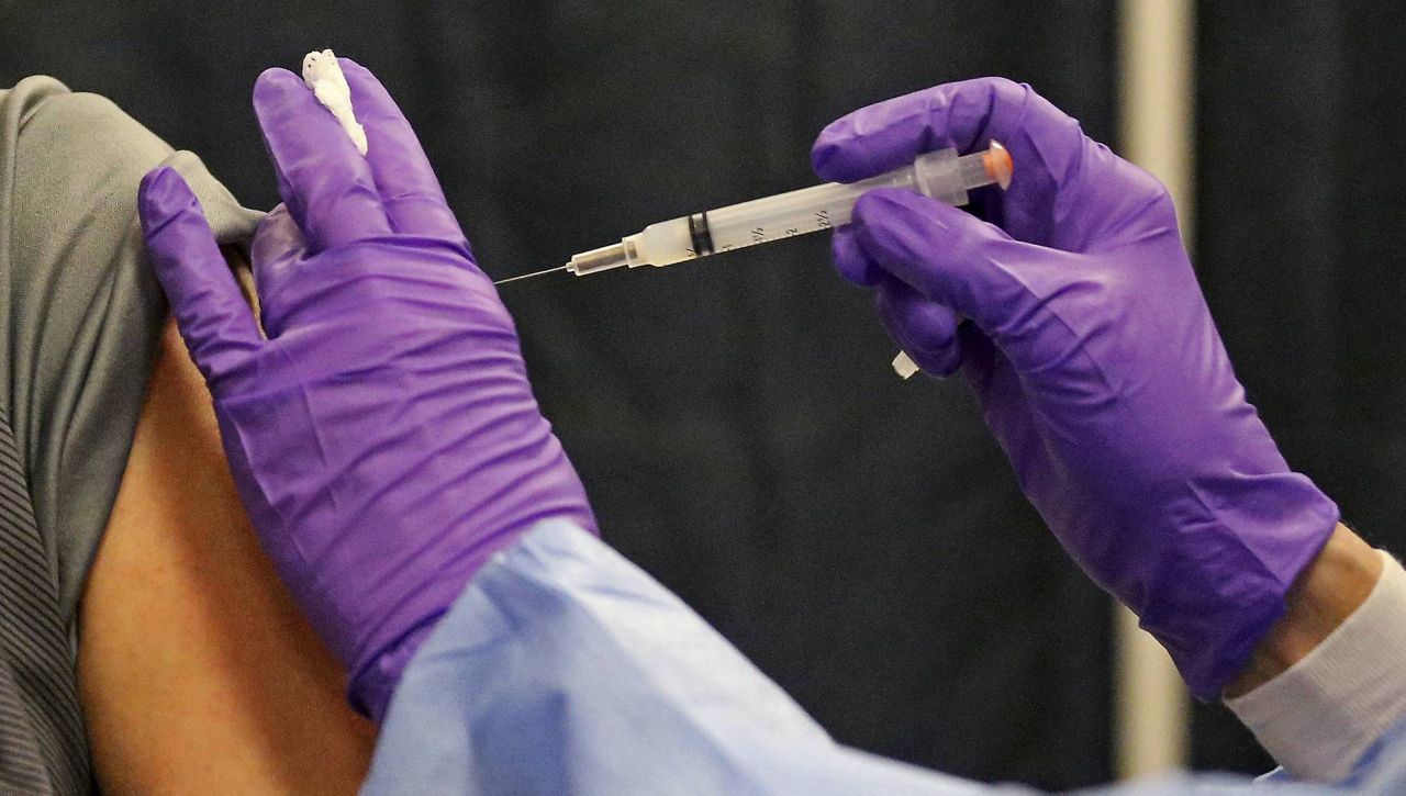 A man gets a COVID-19 vaccine at a mass vaccination site at the Natick Mall in Natick, Mass., on Feb. 24. (AP Photo, File)