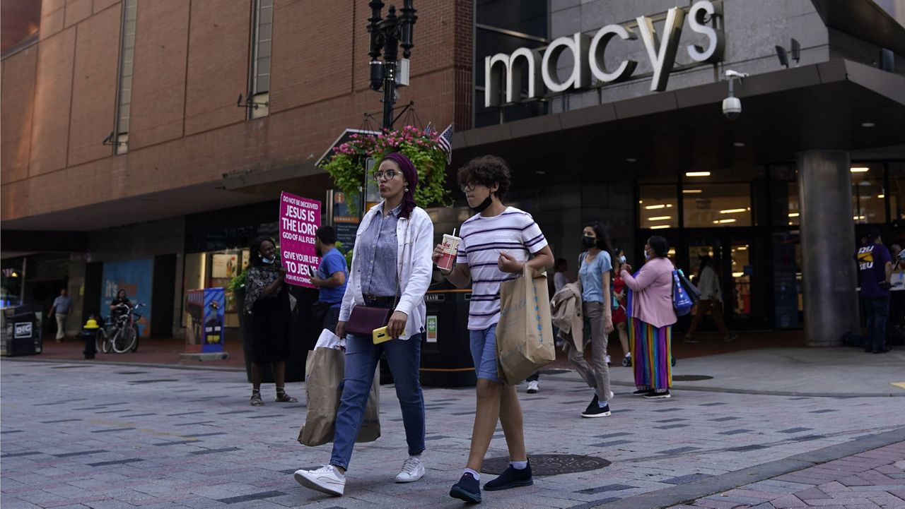 Pedestrians pass the Macy's store in the Downtown Crossing shopping area, in Boston. (AP Photo/Charles Krupa, File)
