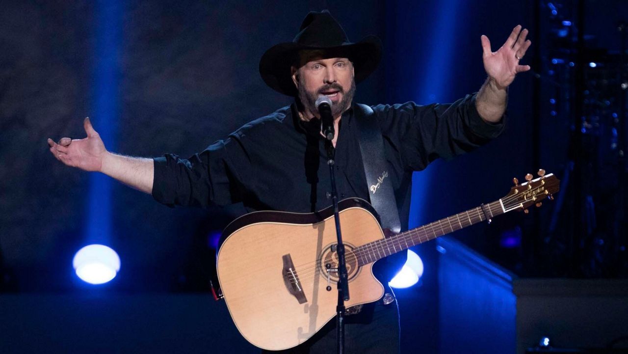 In this March 4, 2020, file photo, country star Garth Brooks performs on stage during the 2020 Gershwin Prize Honoree's Tribute Concert at the DAR Constitution Hall in Washington. Brooks is canceling his tour dates in five cities, citing a rising number of COVID-19 cases. He will cancel his planned next shows in Ohio, North Carolina, Maryland, Massachusetts and Tennessee. (Photo by Brent N. Clarke/Invision/AP, File)