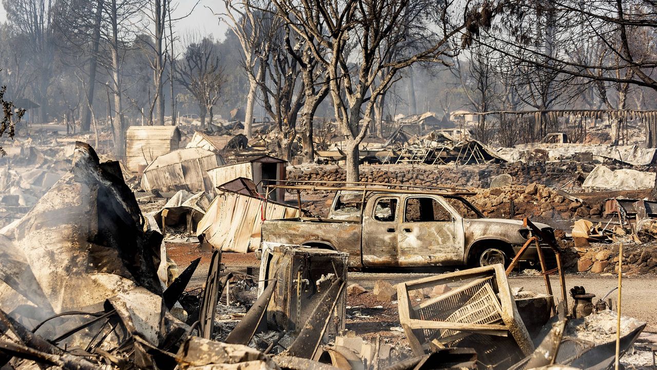 Scorched homes and cars line Cache Creek Mobile Home Estates where the Cache Fire leveled dozens of homes on Wednesday, Aug. 18, 2021, in Clearlake, Calif. (AP Photo/Noah Berger)