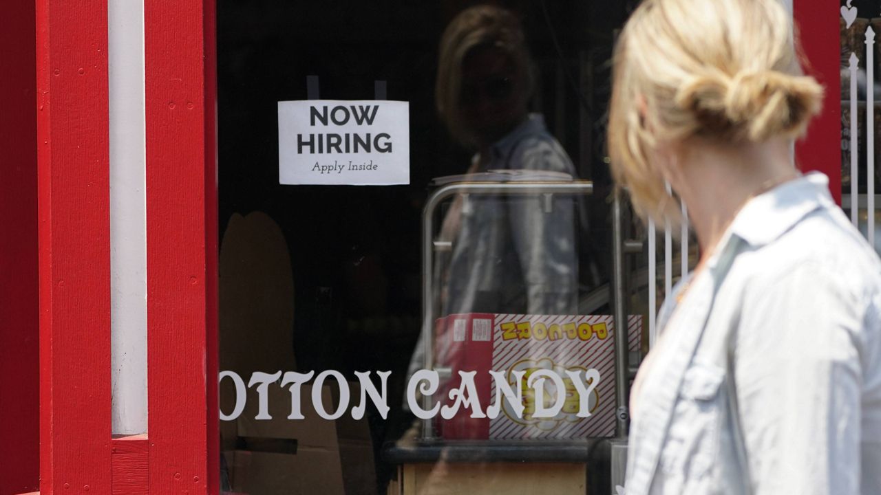 A hiring sign is posted in the window of The Wharf Chocolate Factory at Fisherman's Wharf in Monterey, Calif., on Aug. 6. (AP Photo/Rich Pedroncelli)