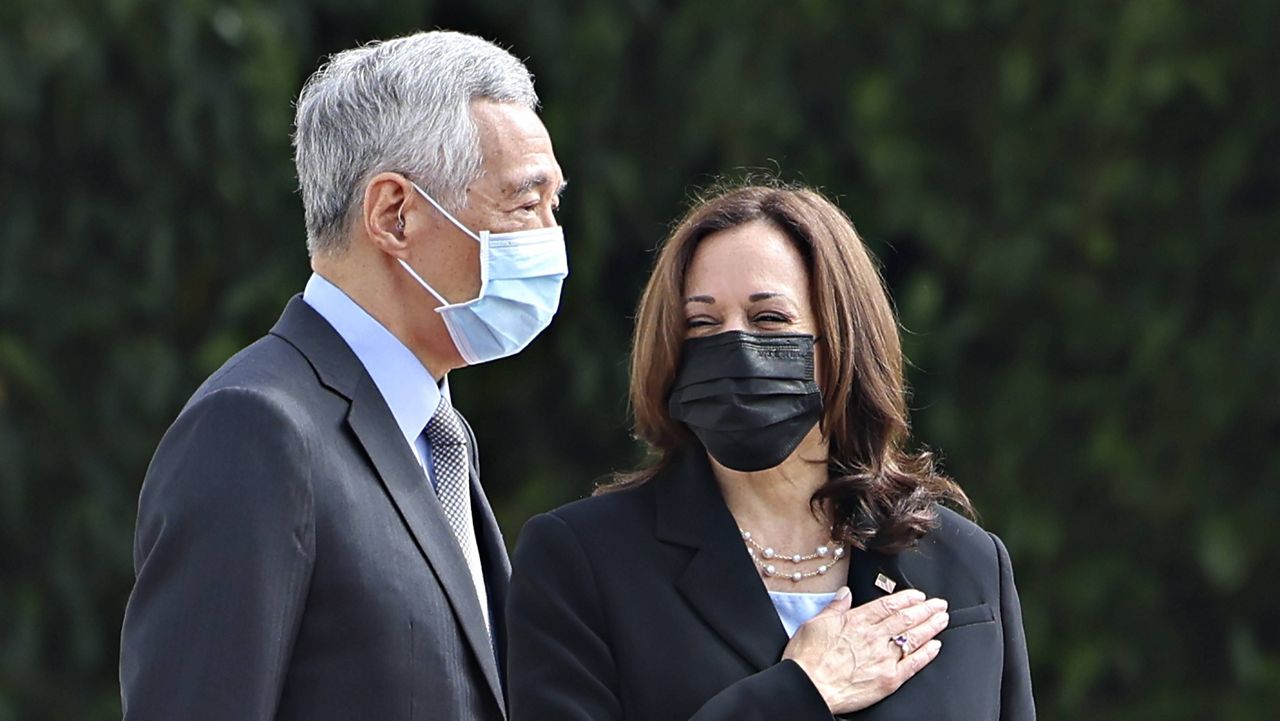 U.S. Vice President Kamala Harris, right, stands next to Singapore's Prime Minister Lee Hsien Loong during a welcome ceremony at the Istana in Singapore on Monday. (Evelyn Hockstein/Pool Photo via AP)