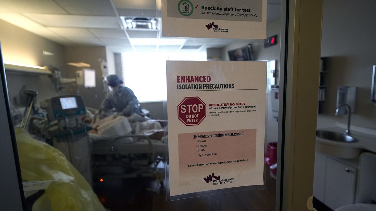 Isolation precautions are posted on a door of a patient suffering from COVID-19, in an intensive care unit at the Willis Knighton Medical Center in Shreveport, La., Tuesday, Aug. 17, 2021. (AP Photo/Gerald Herbert)