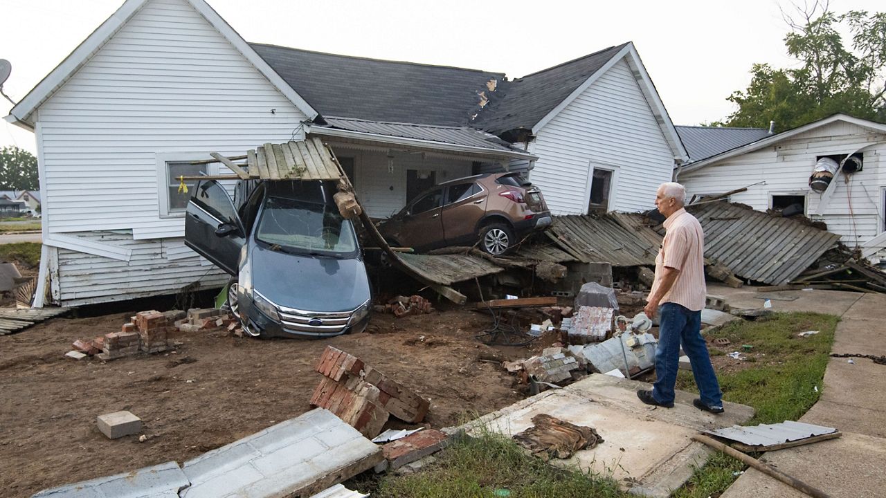Ernest Hollis looks at his grand daughter's house, one of many that were devasted by a recent flash flood, shown Monday, Aug. 23, 2021, in Waverly, Tenn. (AP Photo/John Amis)