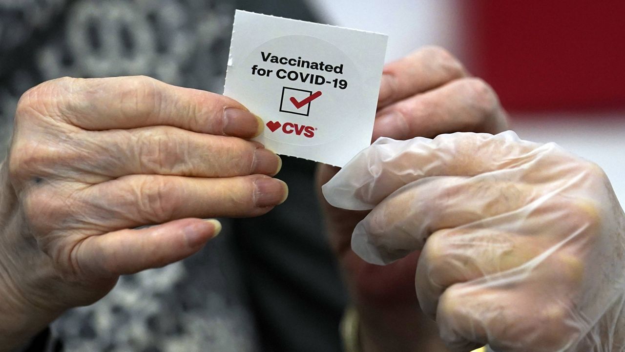 In this March 1, 2021, file photo, a patient receives a sticker after receiving a shot of the Moderna COVID-19 at a CVS Pharmacy branch in Los Angeles. (AP Photo/Marcio Jose Sanchez, File)