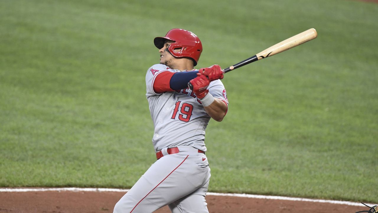 Los Angeles Angels' Juan Lagares (19) watches his two-run home run which scored Los Angeles Angels' Jo Adell hit against Baltimore Orioles starting pitcher Spenser Watkins during the second inning of a baseball game Tuesday, Aug. 24, 2021, in Baltimore. (AP Photo/Terrance Williams)