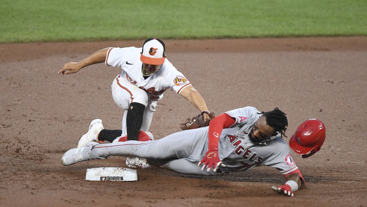 Los Angeles Angels' Jo Adell is tagged out by Baltimore Orioles shortstop Ramon Urias while trying to stretch a single into a double during the second inning of baseball game Wednesday, Aug. 25, 2021, in Baltimore. (AP Photo/Terrance Williams)
