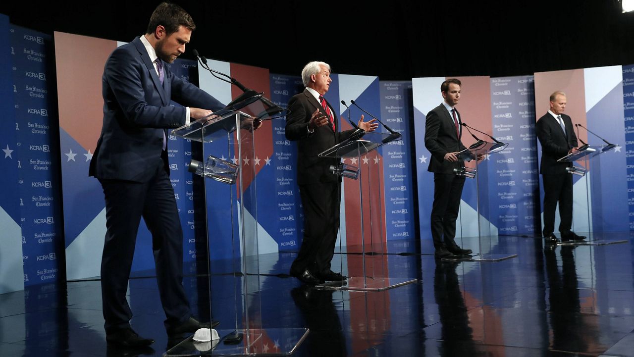 Republican John Cox, center, speaks as Democrat Kevin Paffrath, let, and Republicans Kevin Kiley and Kevin Faulconer, right, listen during a debate between candidates for the upcoming California recall election, held by KCRA 3 and the San Francisco Chronicle in Sacramento, Calif., on Wednesday, Aug. 25, 2021. (Scott Strazzante/San Francisco Chronicle via AP, Pool)