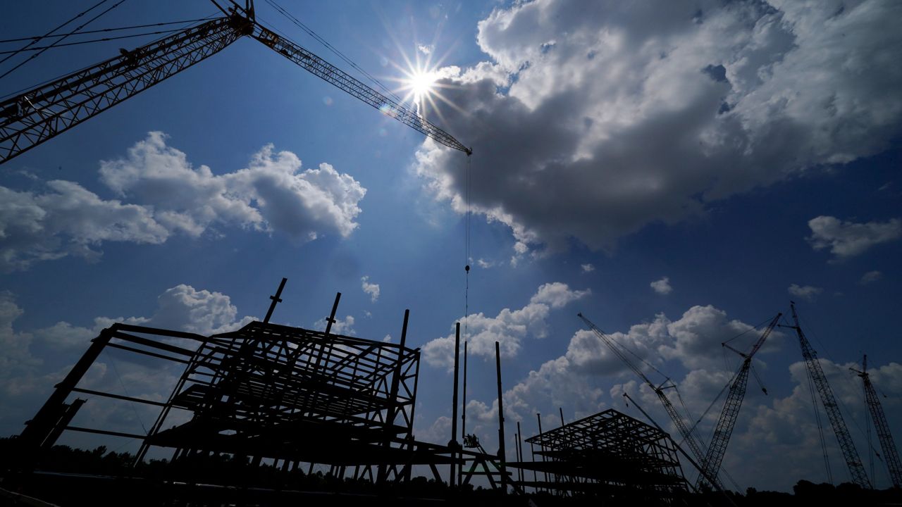 Construction personnel work on Carolina Panthers' state-of-the-art team headquarters and practice facility Tuesday, Aug. 24, 2021, in Rock Hill, S.C. "The Rock" will host all of the team's offices and training/locker room facilities, along with three outdoor grass practice fields, one indoor artificial field and another outdoor artificial field that is part of a 5,000-seat multipurpose stadium that can also be used to host high school football and soccer games, concerts, car shows and much more. (AP Photo/Chris Carlson)