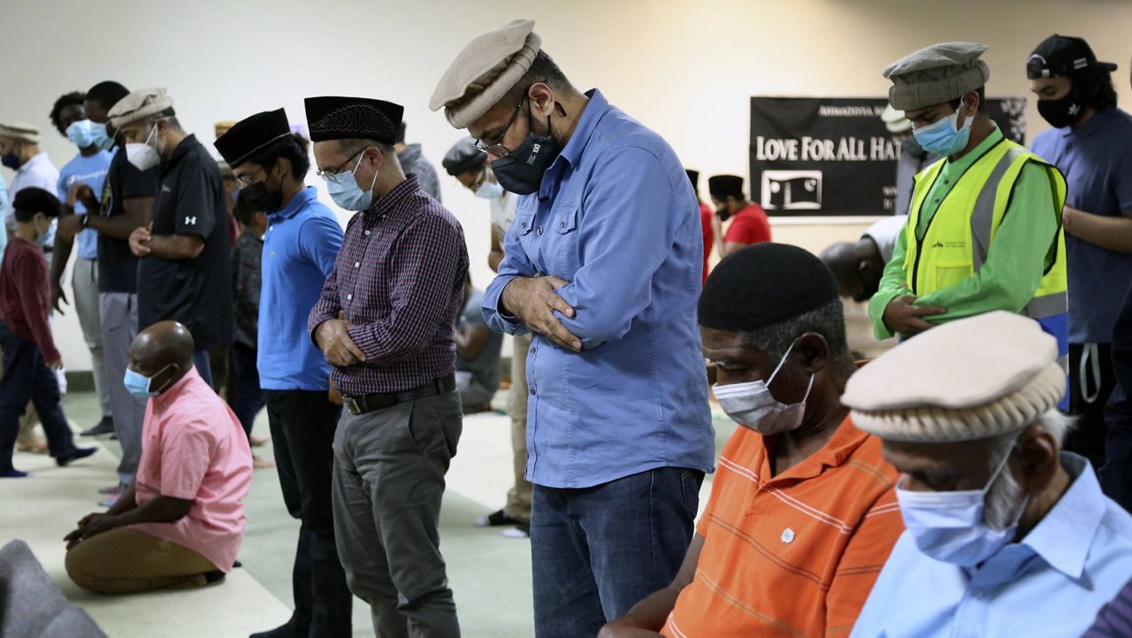 Mansoor Shams, center, and other community members attend Friday prayer Aug. 13 in Rosedale, Md. (AP Photo/Jessie Wardarski)
