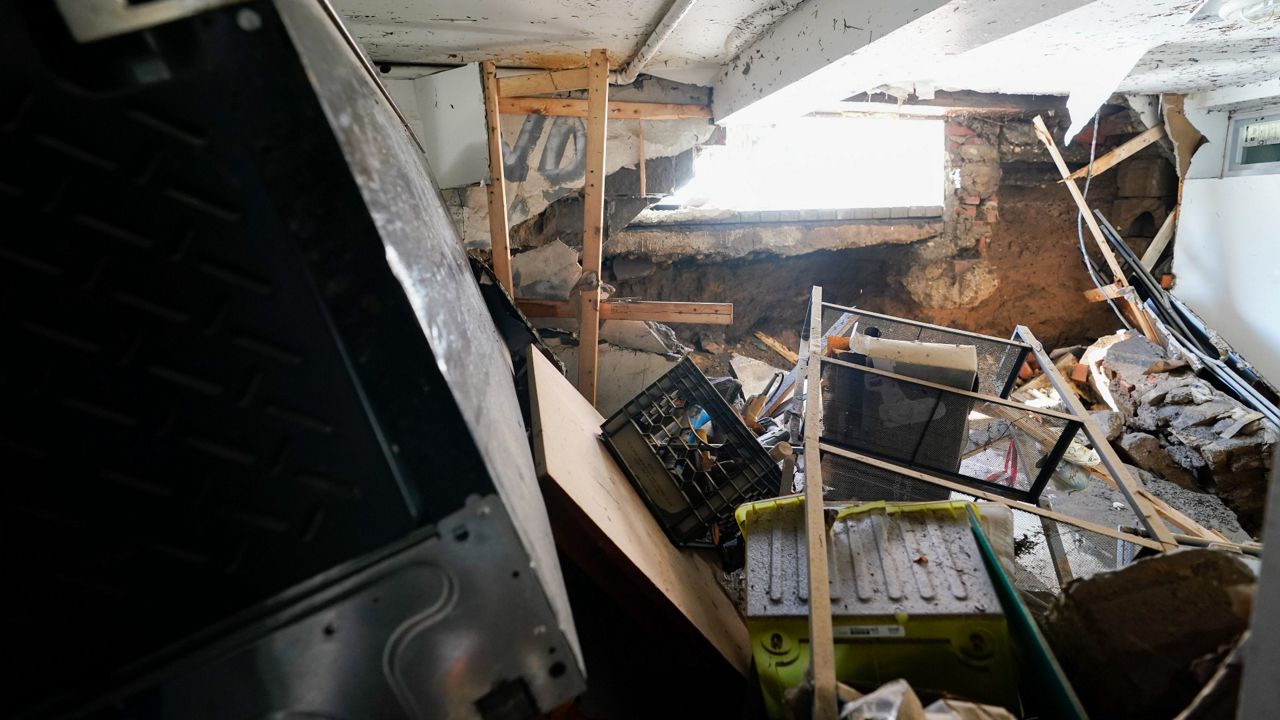 A hole in the foundation where a window once was and flood waters rushed in is seen in the basement apartment on 153rd St. in Flushing, Queens, Thursday, Sept. 2, 2021. (AP Photo/Mary Altaffer)